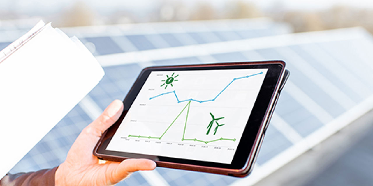 Tablet with graphics in front of solar panels